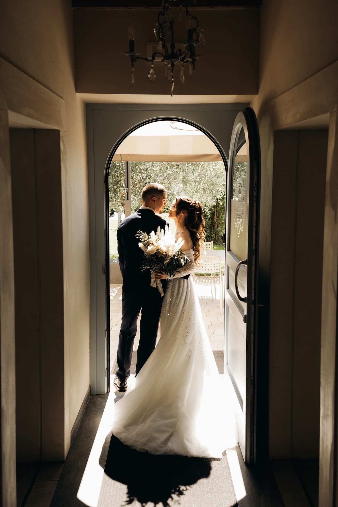 Bride and groom standing in an architectural doorway